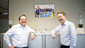 Gerben Janson (links) en Joost van den Berg van Leidse Letselschade Advocaten bij een foto van het kampioensteam in 2021.